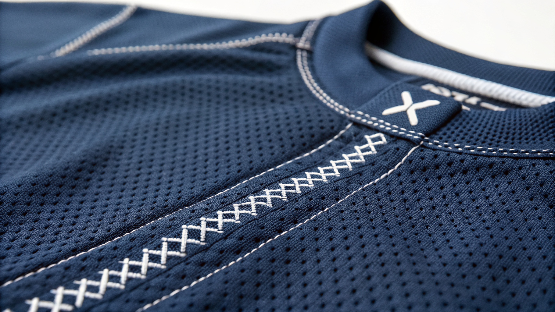 Box-X Stitch close-up on navy cycling jersey