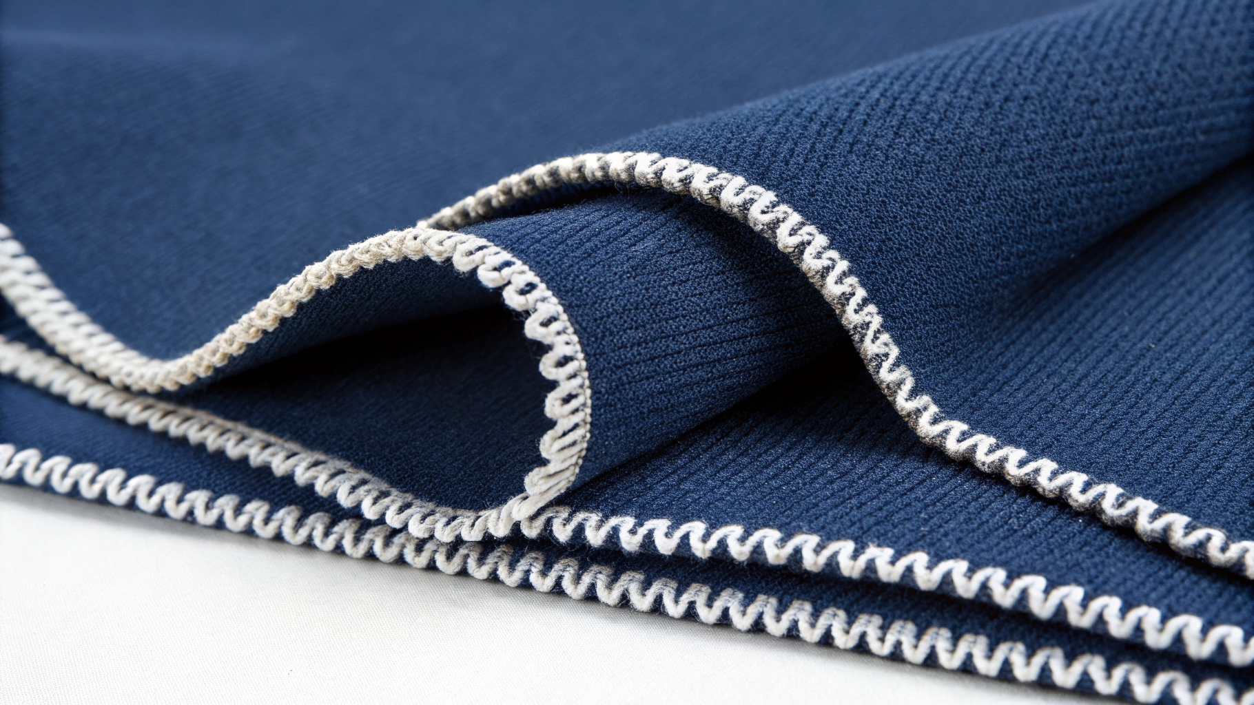 Three-Thread Overlock close-up on navy sportswear fabric